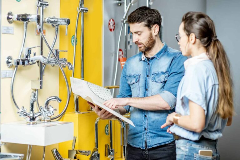 Couple choosing shower faucet in the shop